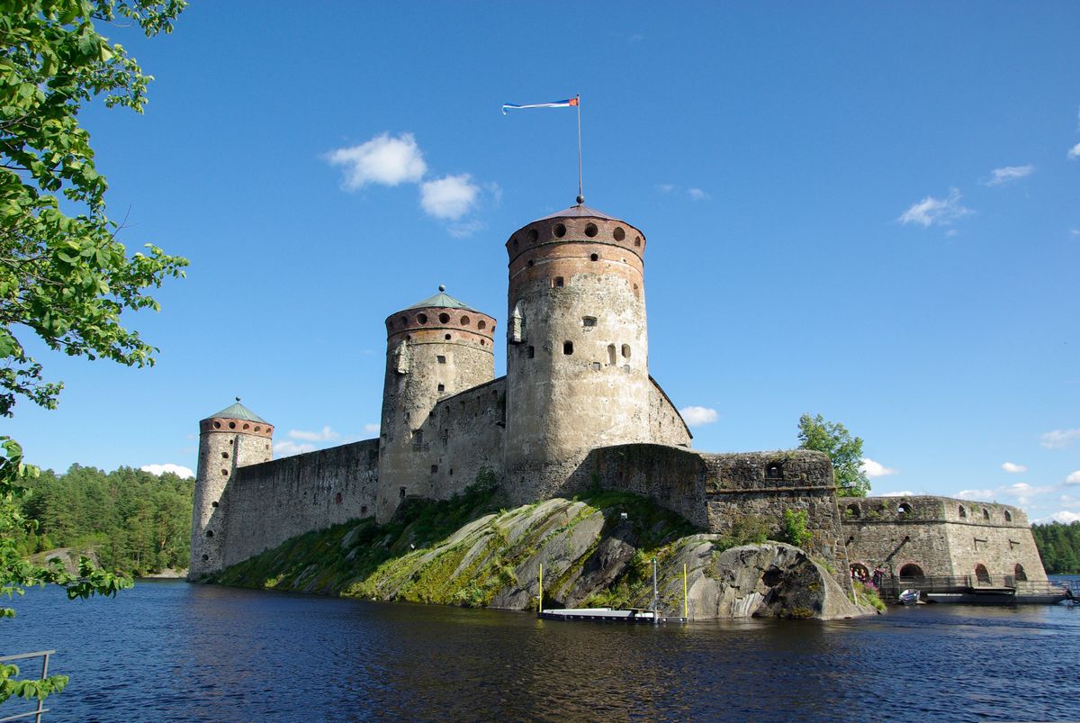 Hrad Olavinlinna se tyčí nad vodní hladinou v&nbsp;malebném prostředí finského města Savonlinna.